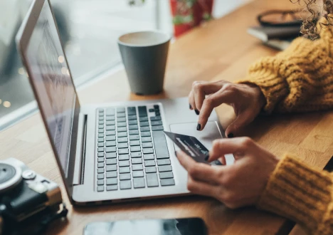 Person making a card payment on a laptop